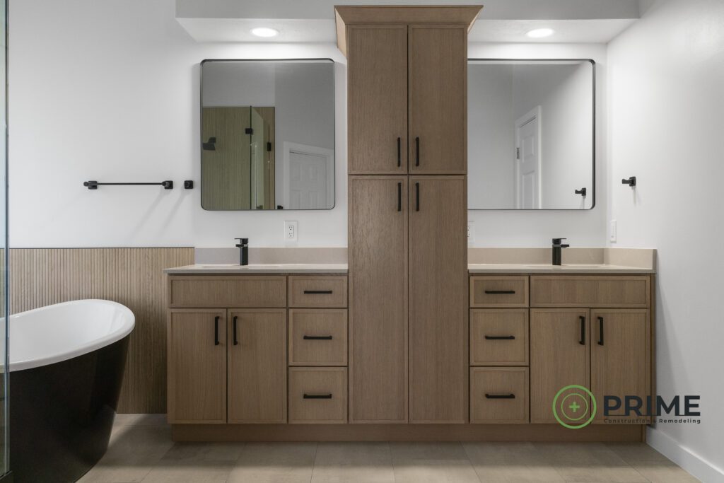 Bathroom remodeling in Austin featuring a contemporary design with double vanity, wood cabinets, and freestanding tub