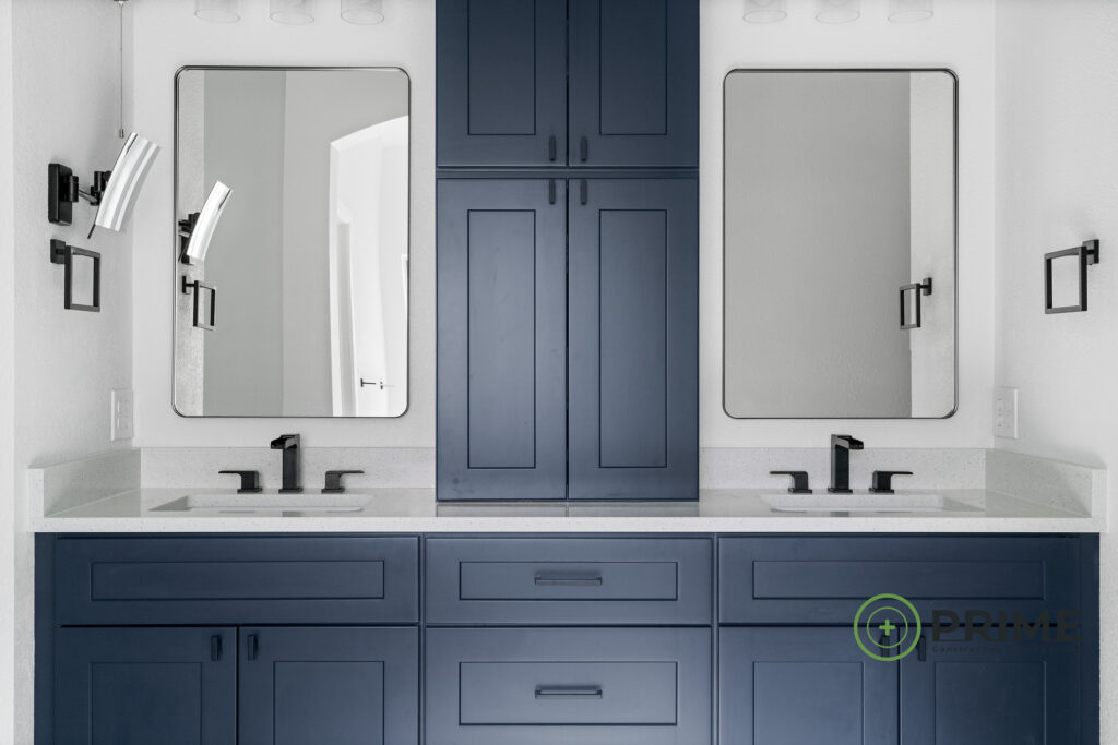 Bathroom remodeling in Austin featuring double sinks, blue cabinets, and modern fixtures for a stylish renovation