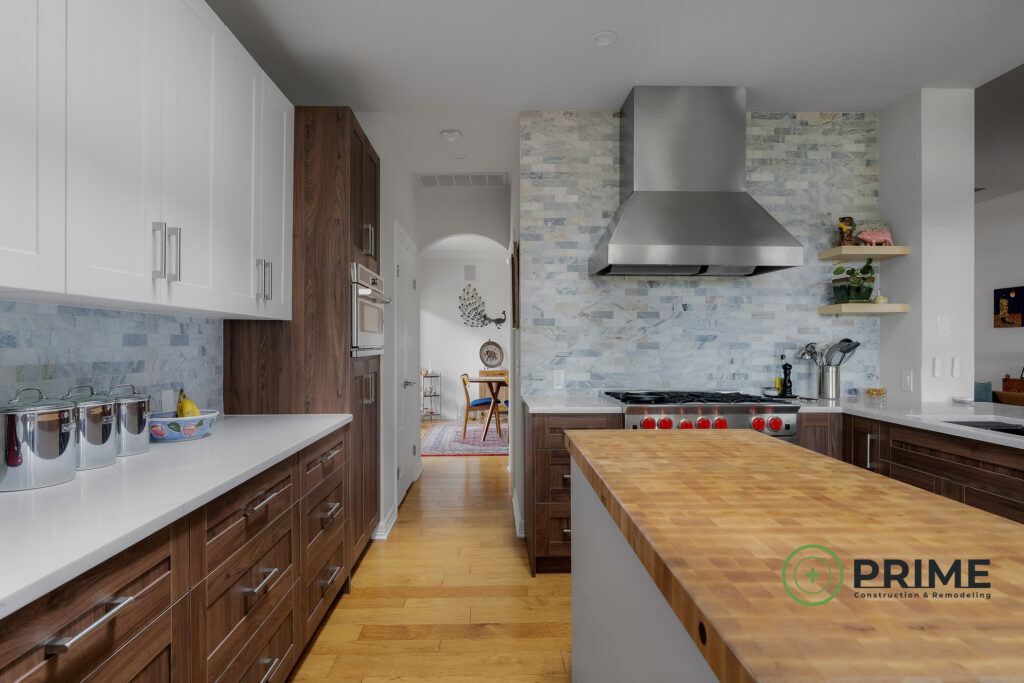Austin TX kitchen remodeling showcasing a modern kitchen with white and dark wood cabinets, stainless appliances, and tile backsplash