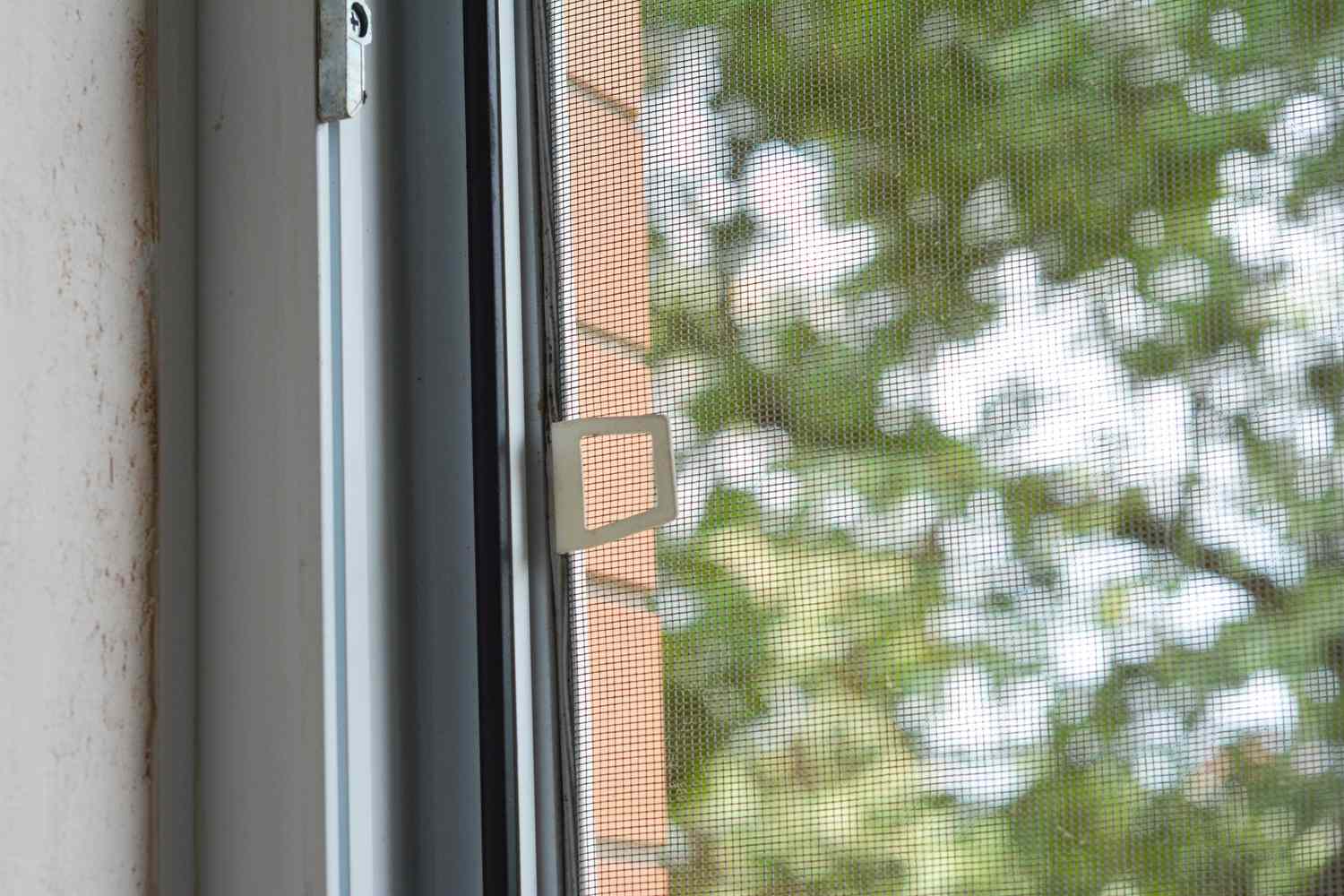 Home remodeling company Austin featuring window with metal fly screen and pull tab, suitable for home renovation upgrades