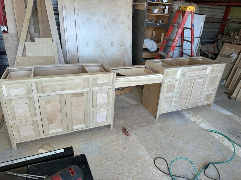 Bathroom remodeling Austin TX featuring unfinished wood bathroom vanities ready for installation in a remodel project