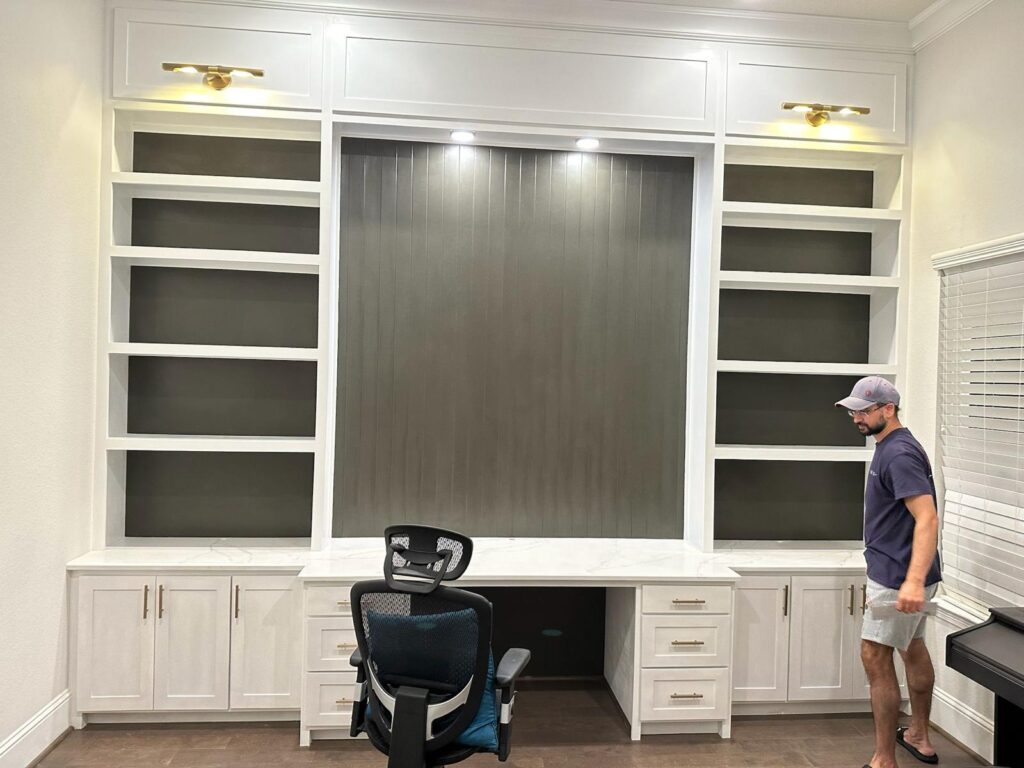 Home remodeling company Austin showcasing modern built-in office desk with marble top and shelves in a remodeled home