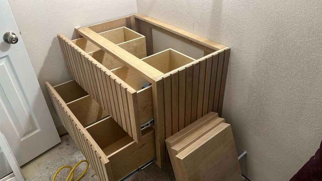 Home remodeling company Austin featuring partially assembled wooden cabinet and panels during kitchen renovation